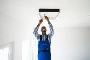 electrician fixing lighting fixture 300x200 2